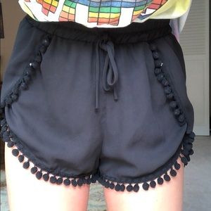 black pompom shorts